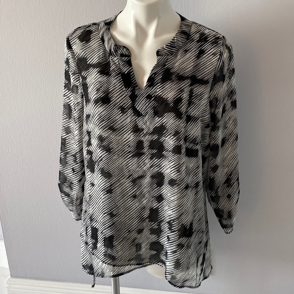 Black and white top with asymmetrical hem. Large